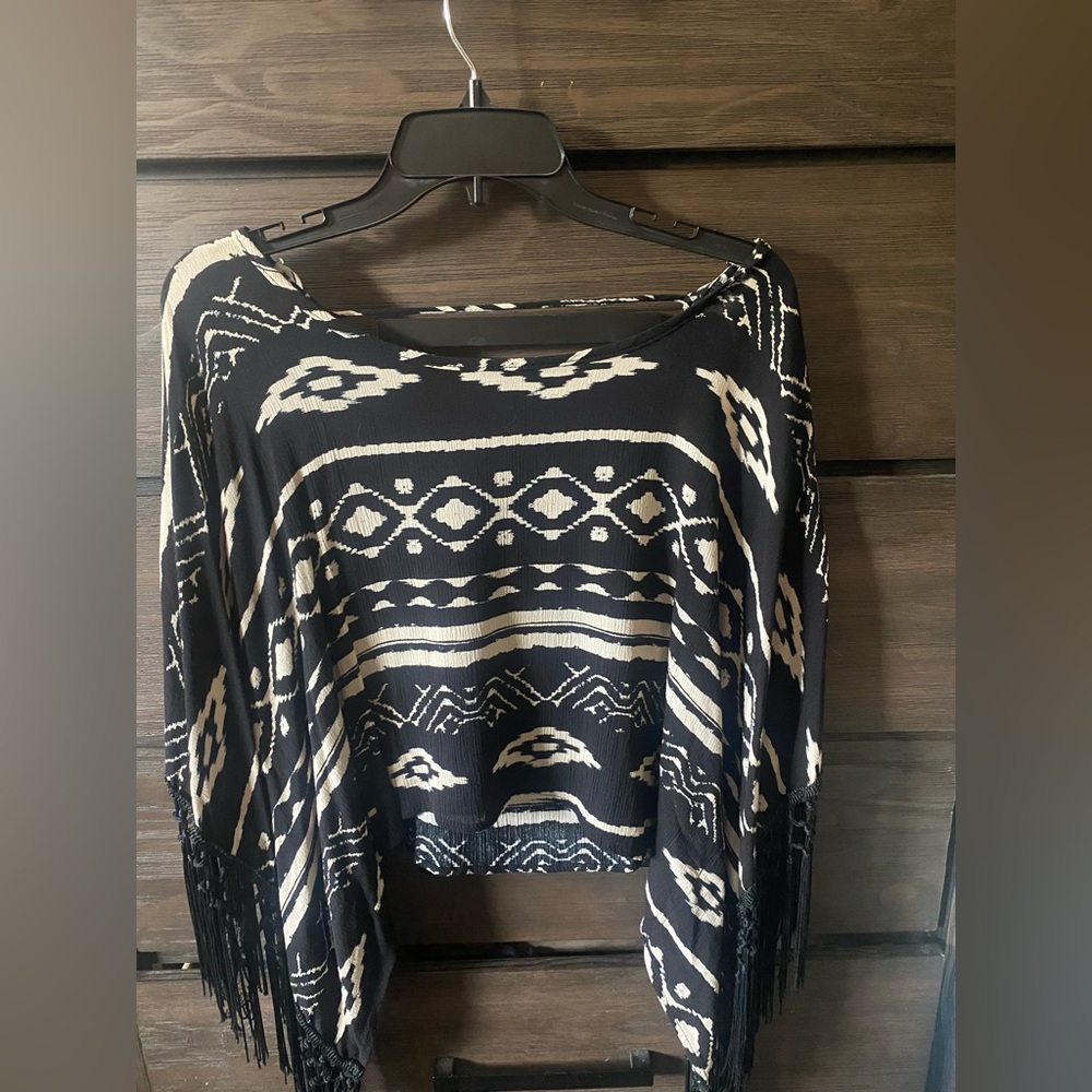 Flowy crop with tassel sleeves and scoop back.